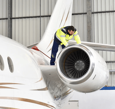 Man checking an airplane turbine. 