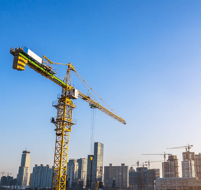 Construction crane with city skyline.