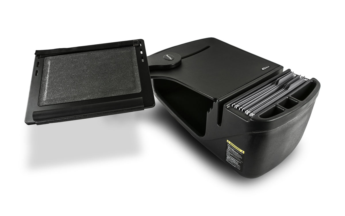 a portable car desk designed for use in the front seat of a vehicle. The desk is made of sturdy black plastic and features a flat work surface with a non-slip top. There’s an extended side panel that can hold documents or small items, and beneath the work surface, there’s a storage compartment for files or office supplies