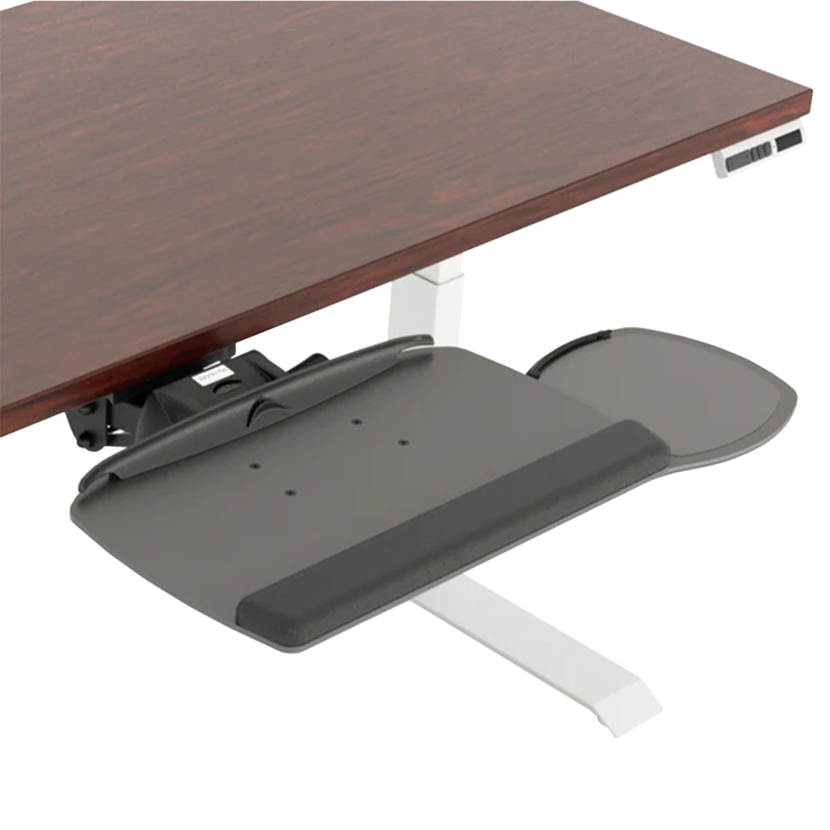 A dark gray under-desk tray with an integrated wrist rest, shown attached to a white desk leg beneath a dark wood desk on a white background.
