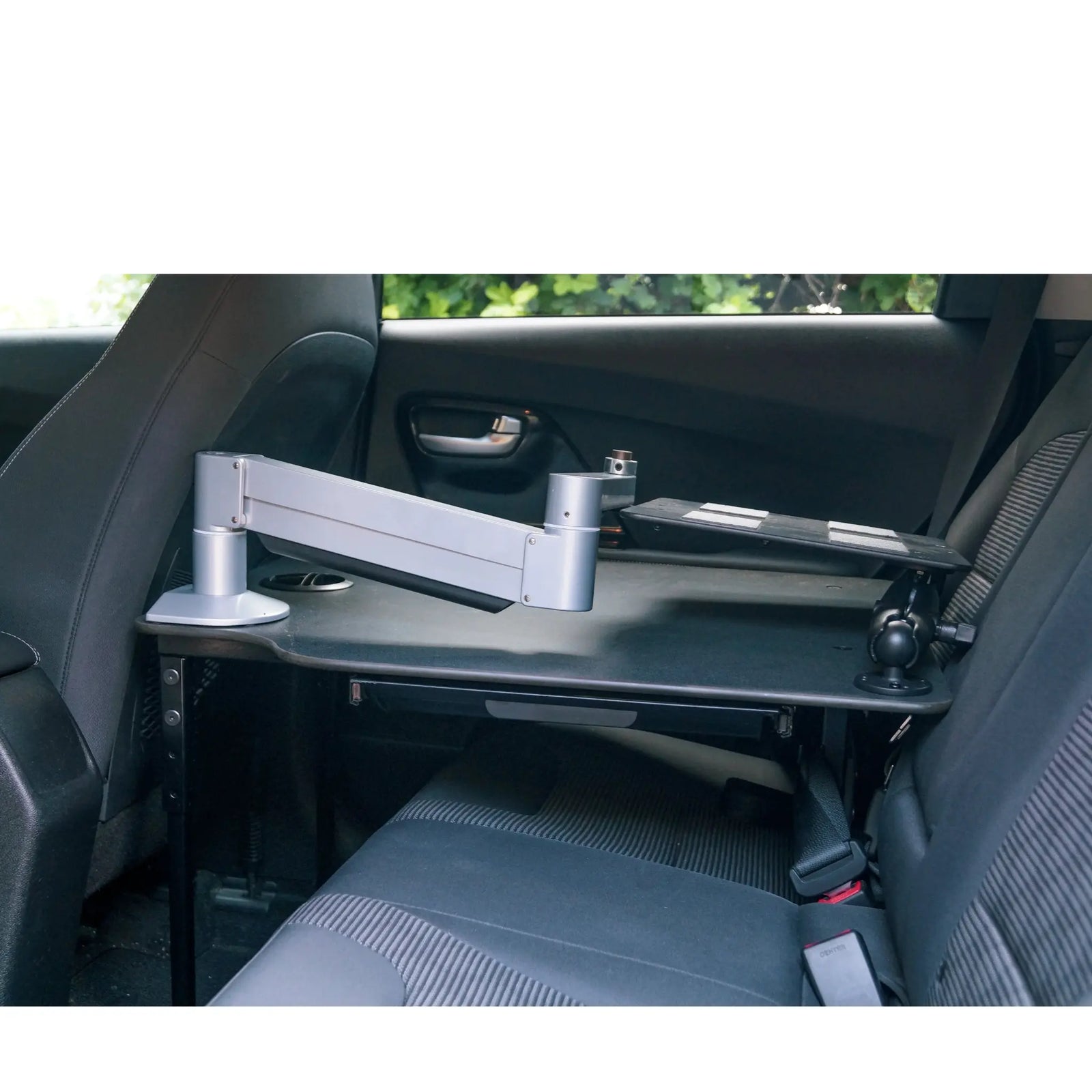 Universal car desk tray with swing away sit-stand laptop arm for ergonomic comfort. 