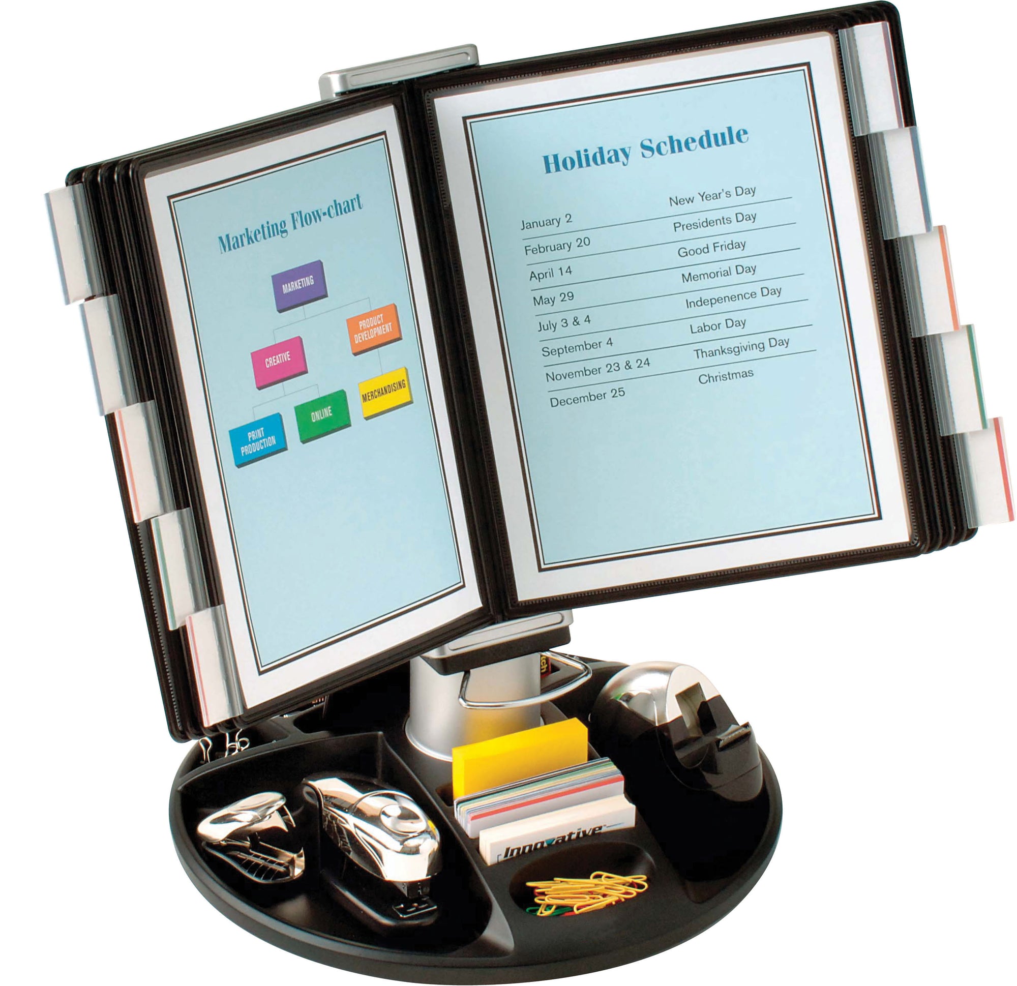  a black, multi-functional document organizer that can rotate. It has two clear display panels where documents can be inserted for easy viewing. One panel displays a document titled “Marketing Flow-chart” and the other shows a “Holiday Schedule.” The base of the organizer contains various compartments filled with office supplies such as paper clips, sticky notes in different colors, and pens