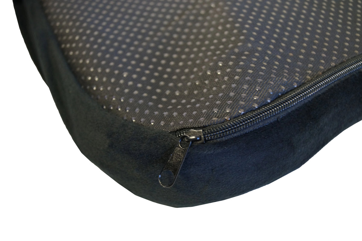 Close up of corner of black gel seat cushion showing the zipper and fabric texture