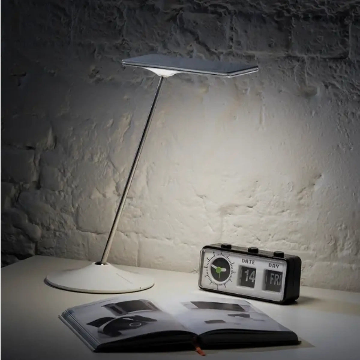 Horizon 2.0 Adjustable LED Desk Lamp illuminating a dark room so somebody can read.