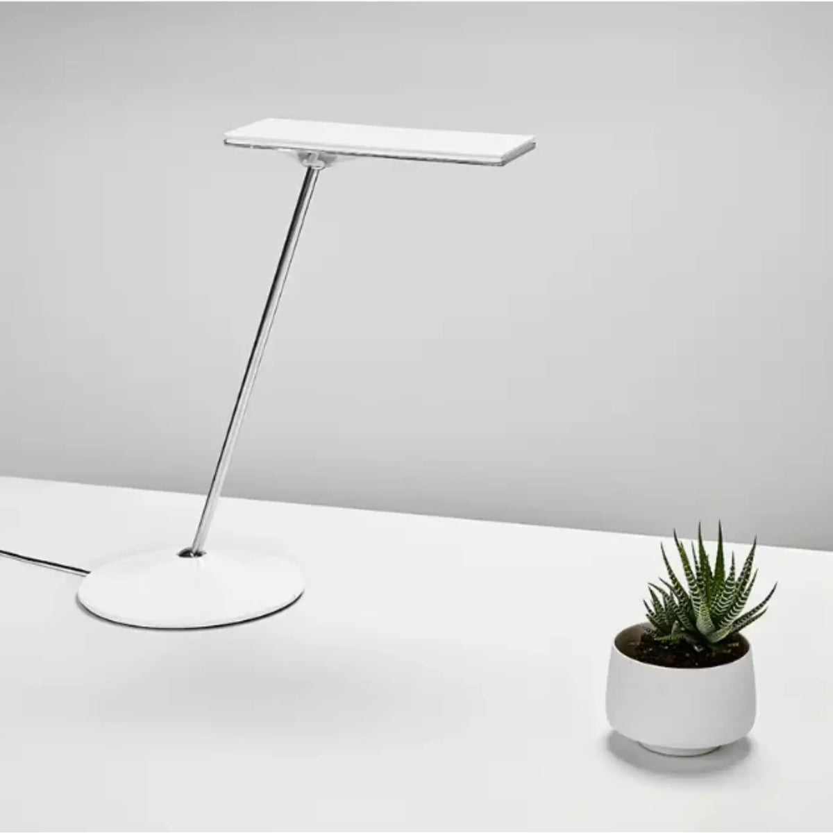 White Horizon 2.0 Adjustable LED Desk Lamp on a desk 