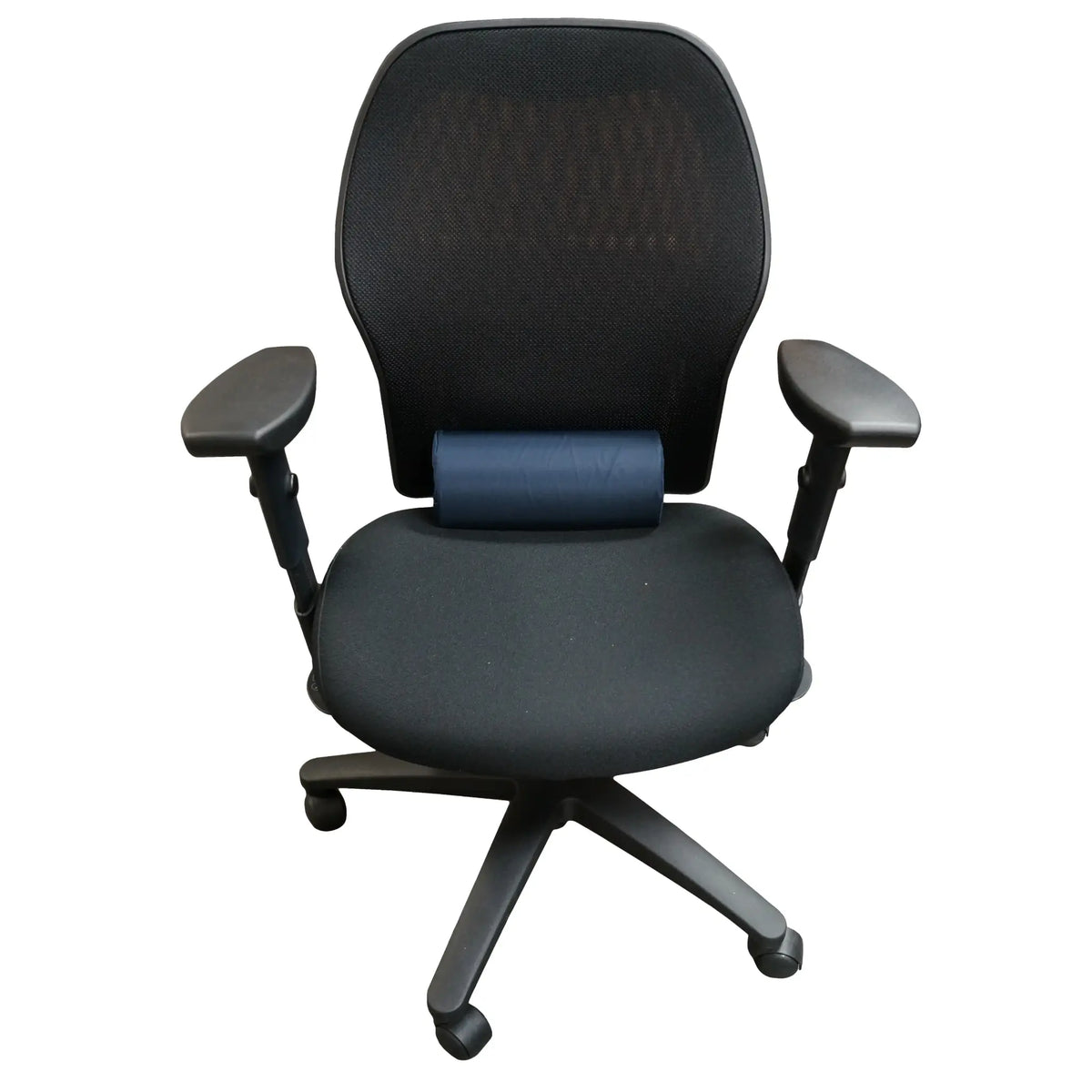 Lumbar support cushion in use on a black office chair.