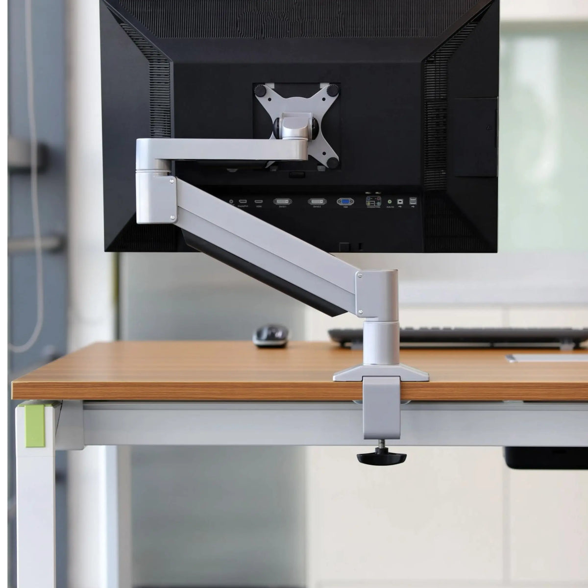 Back view of the monitor arm easily clamped to the desktop