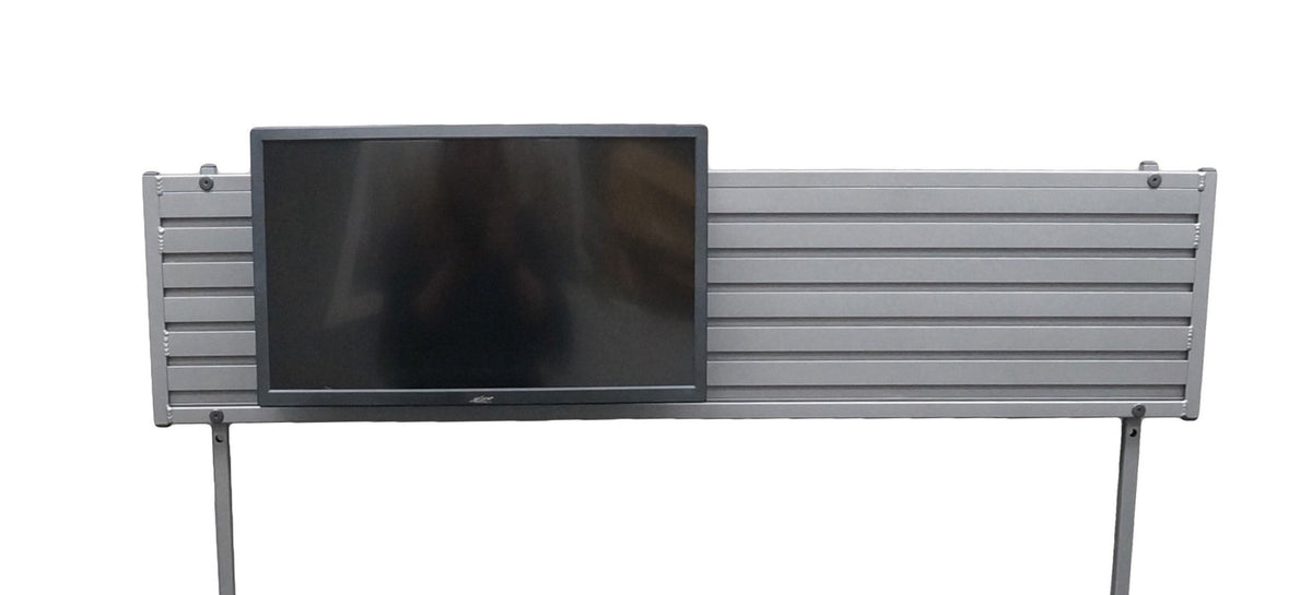 a long ridged piece of silver metal with 2 long metal posts, designed to mount to a desk, screwed to each end. A black computer monitor is mounted to length of metal on the left side