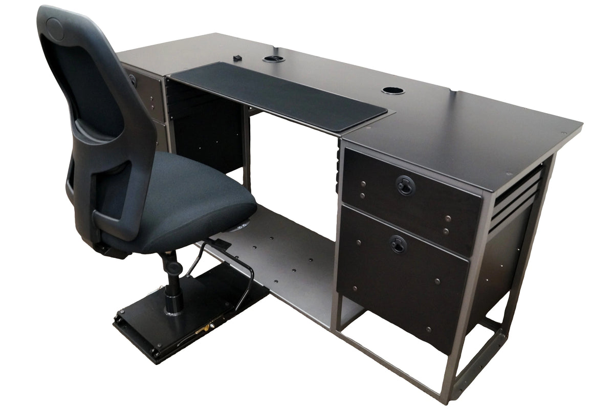 A large flat desk with a black work surface and a connected black chair mounted on a black sliding seat base. The surface features black fabric in the middle meant as a grip for a keyboard and mouse. It has two empty grommet holes as well. The base of the desk is made of 2 sets of black drawers on each side of an open space for the chair. The bottom of the desk is connected together with a large sheet of gray metal to which the sliding black chair is mounted. 