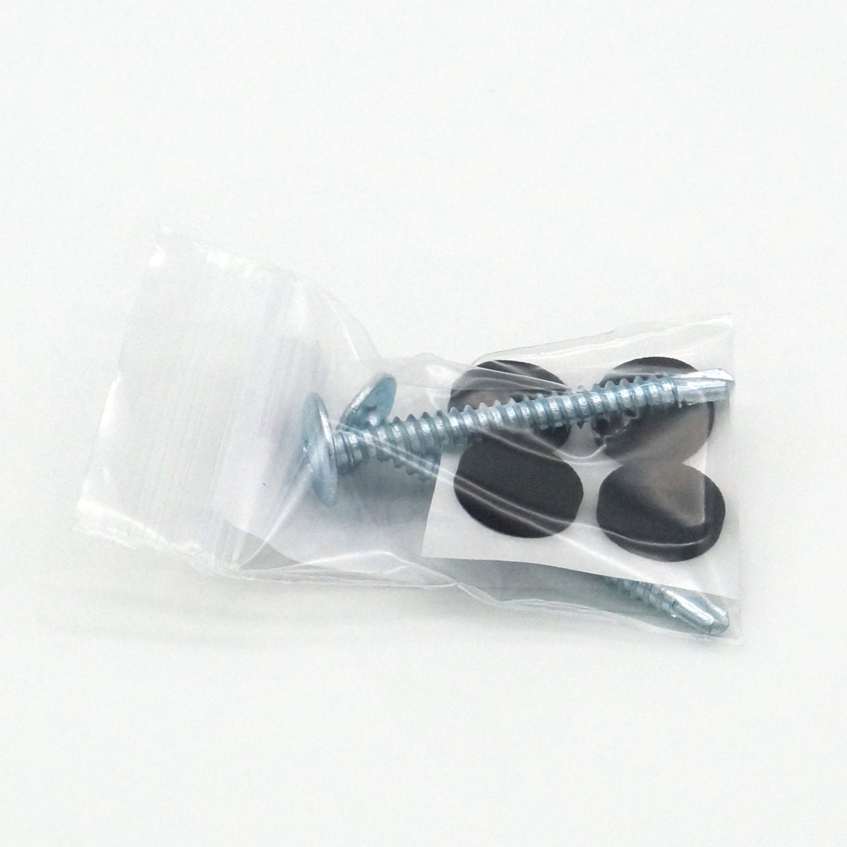 a small plastic bag with 2 long sliver screws and a sheet of 4 round black rubber stickers for mounting